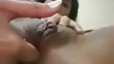 An Indian nude girl fingers her shaved pussy and ass