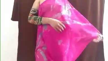 Defenseless Indian girl in a pink sari airs her sex melons in XXX video